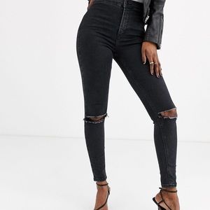 Topshop high wasited ripped Joni Jeans in black. Size: 25W 30L